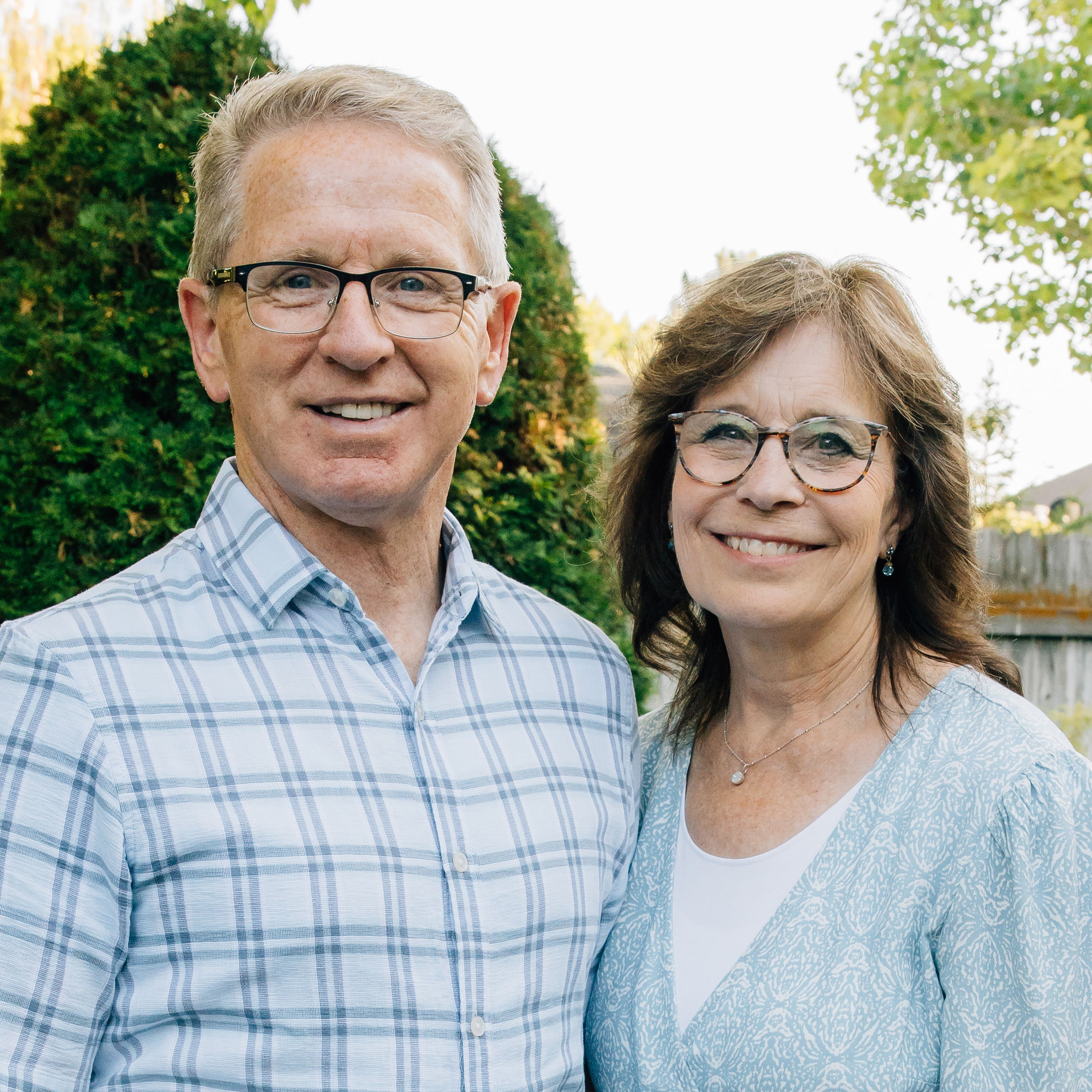 Geri Zollinger and husband Steve standing in their backyard.