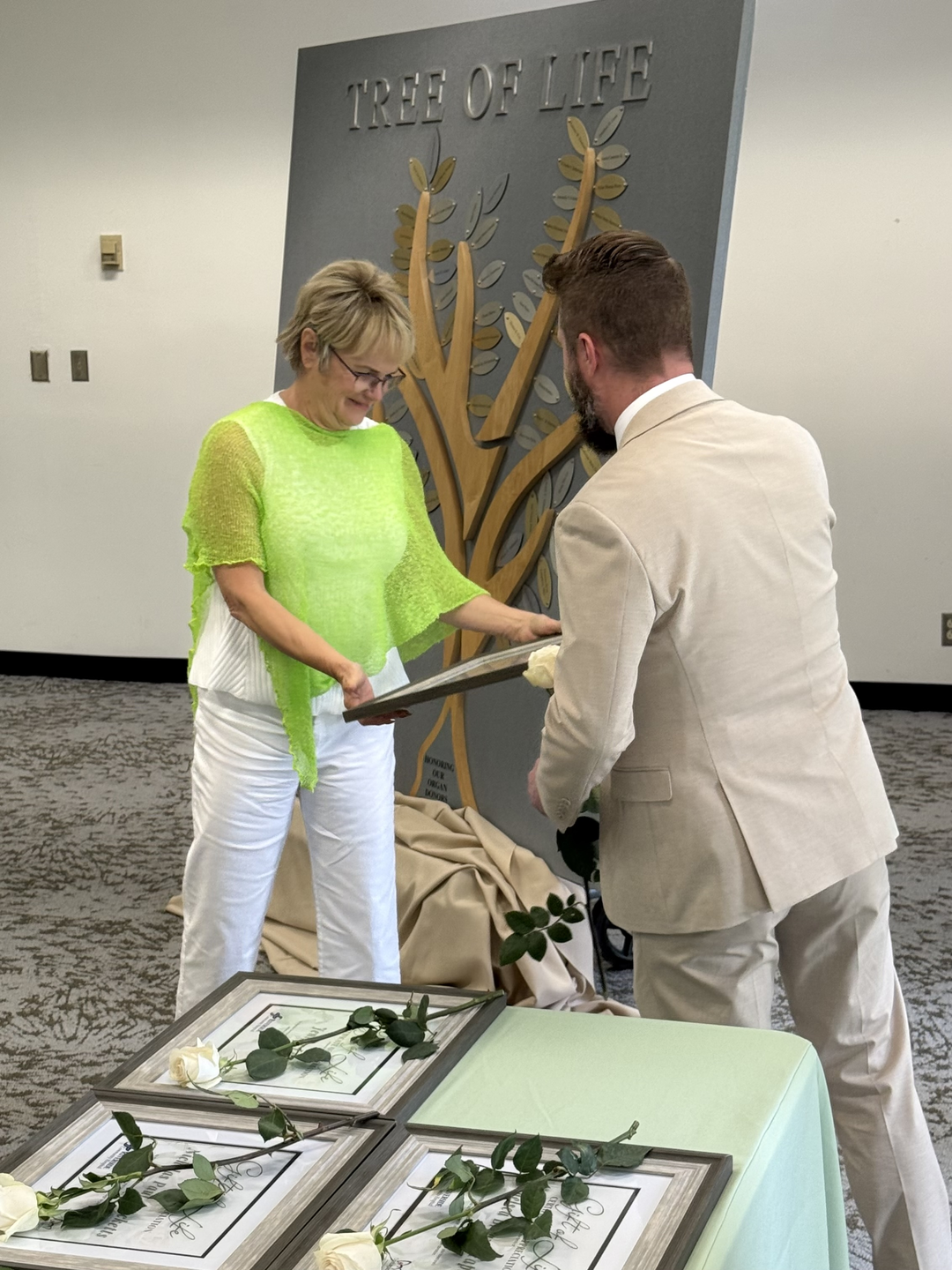 RCH hands a certificate celebrating the life of an organ donor to a family member.jpeg