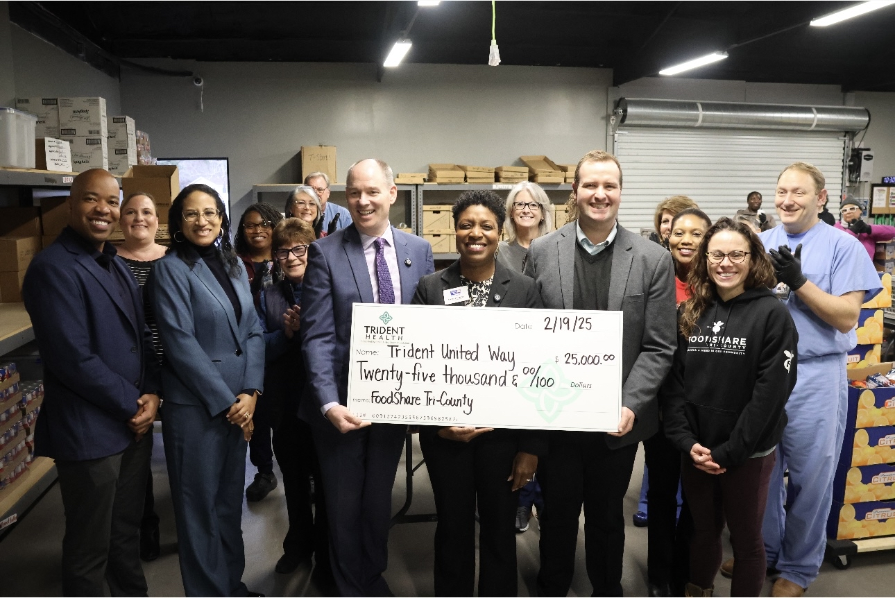 Photo of volunteers holding a large check.