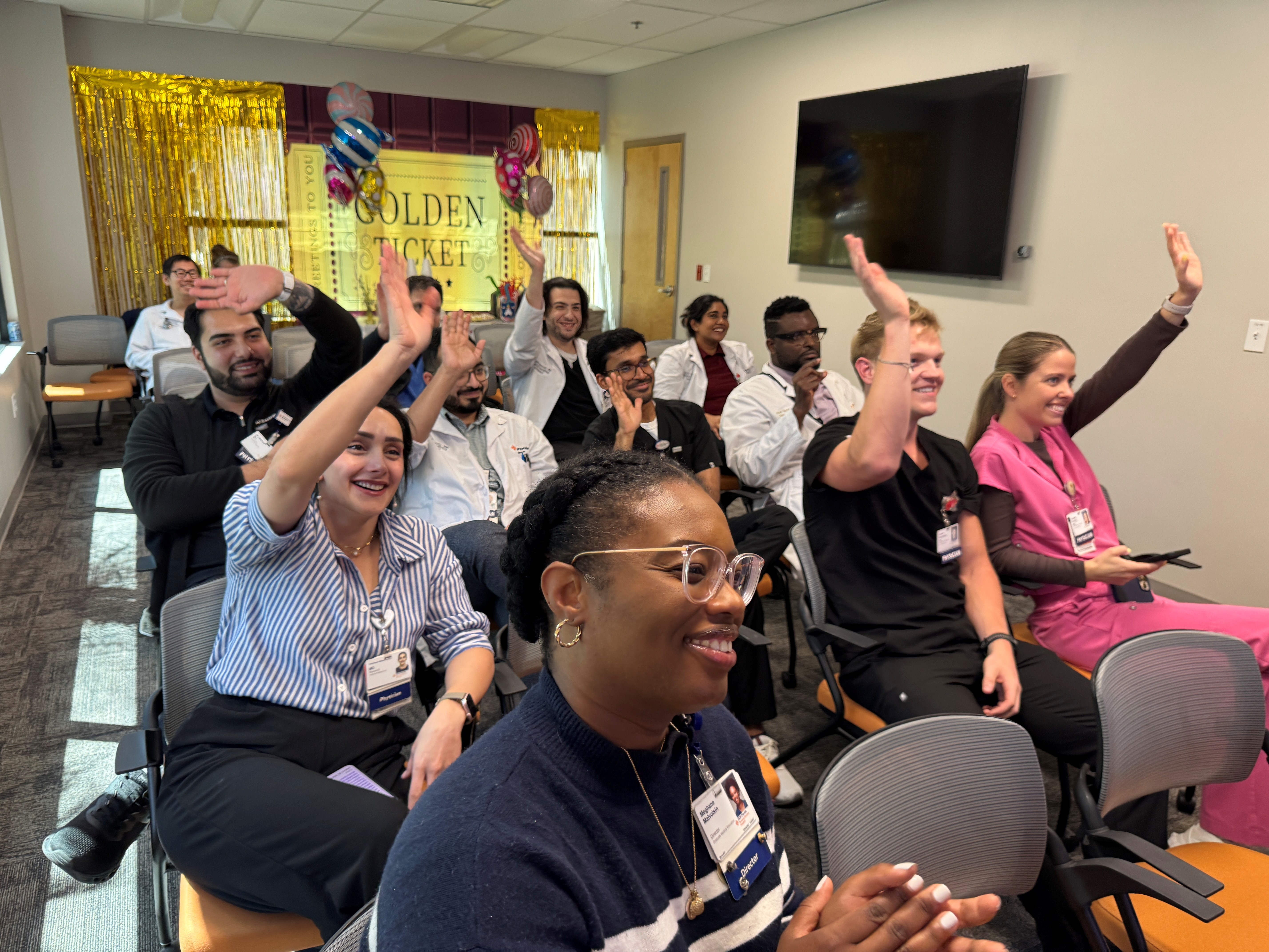 Group of people sitting and waving