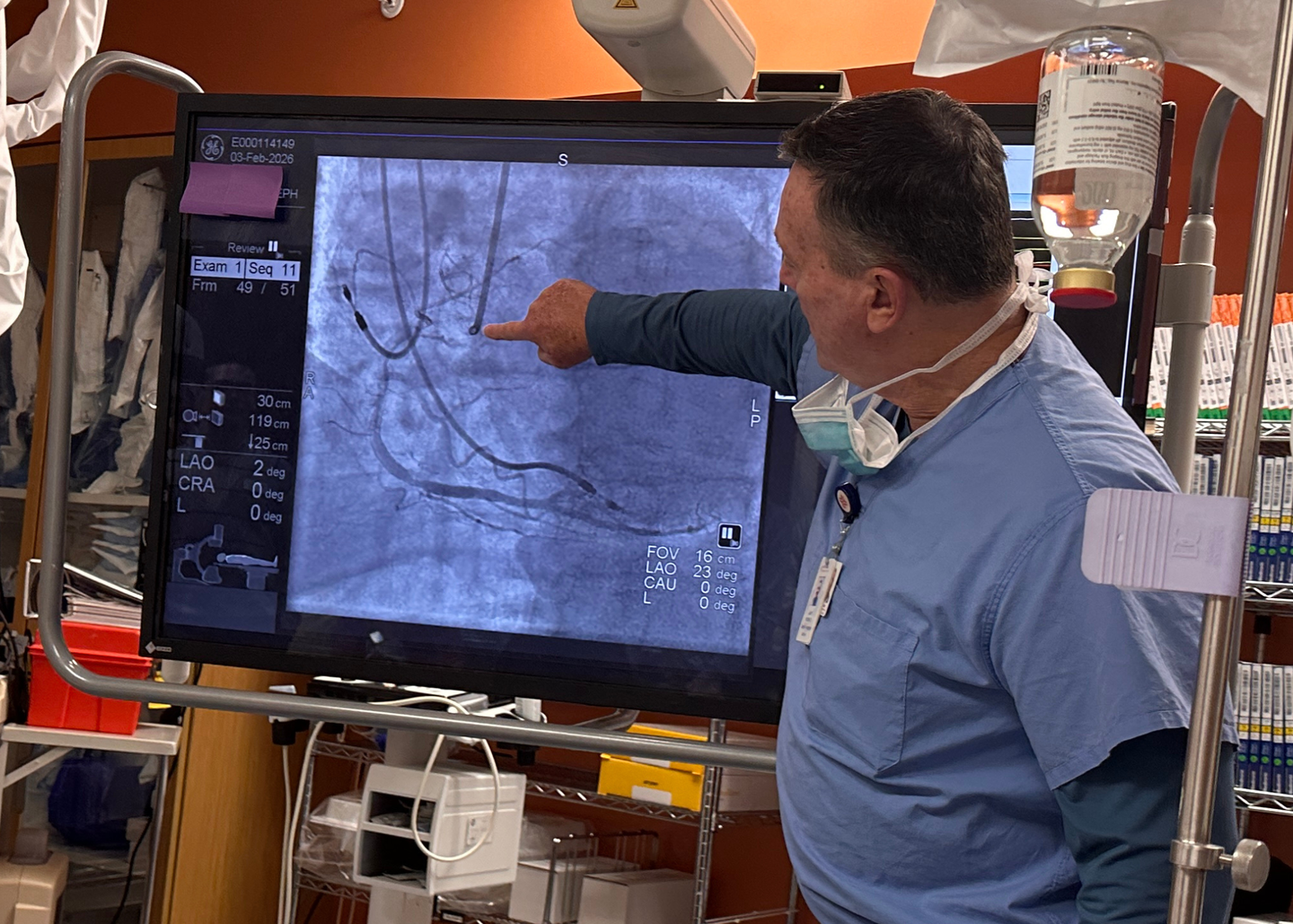 Veteran cardiovascular technician Joe Swann points to an image of a blocked blood vessel during a demonstration in the cardiac catheterization lab at HCA Florida Englewood Hospital.