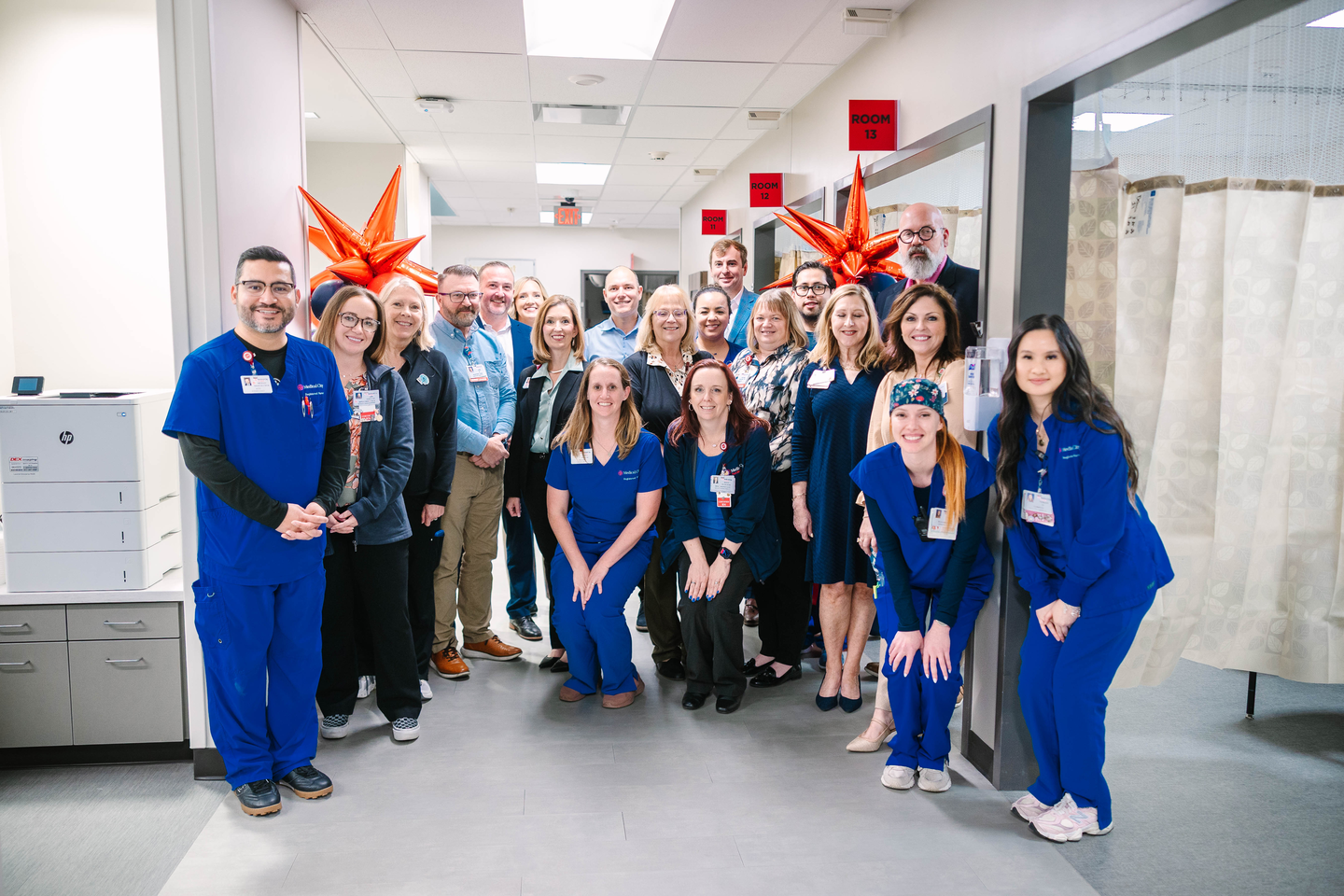 Hospital administrators and ER clinical staff gathered in the newly expanded Medical City Fort Worth emergency department for a group photo.