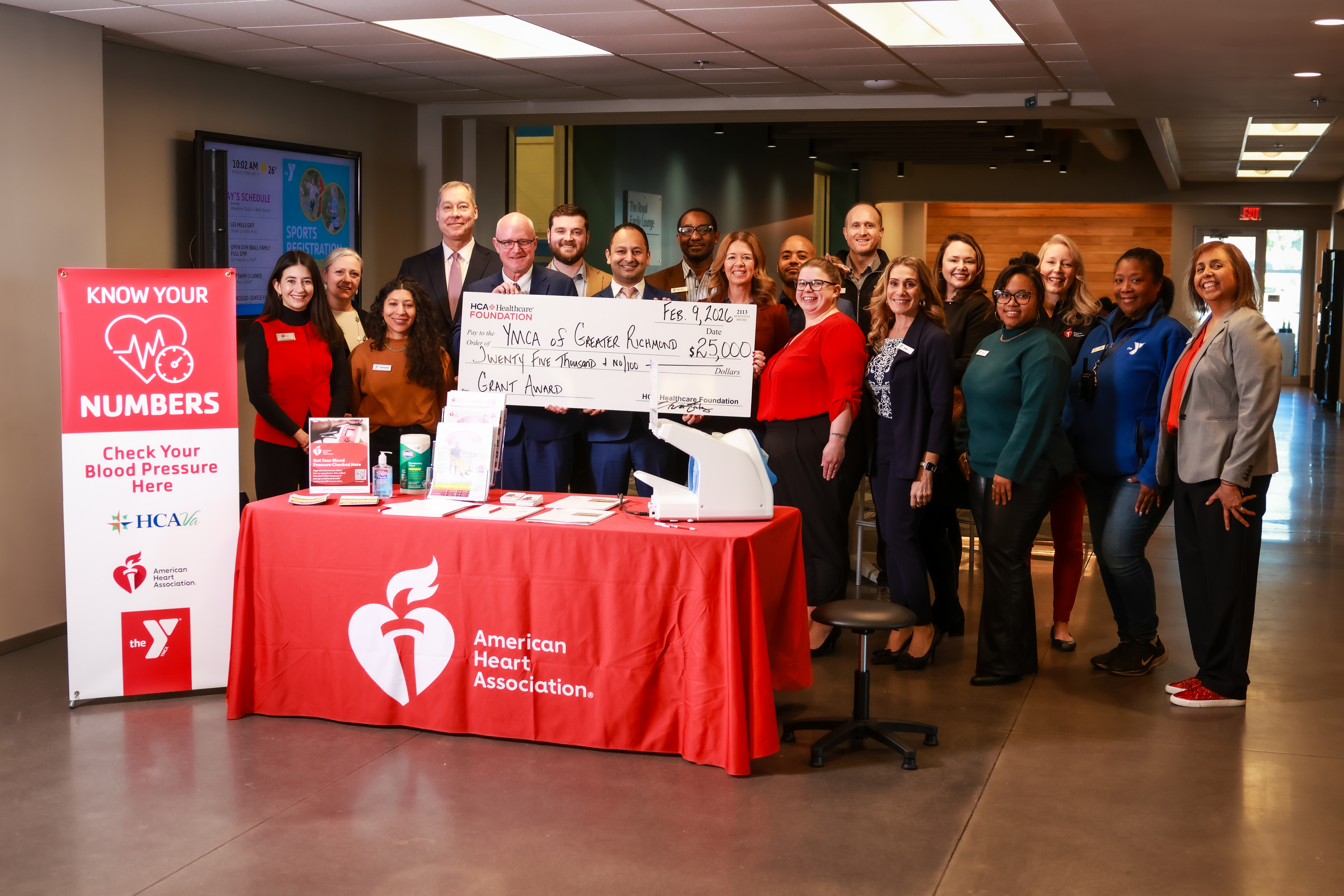 American heart association donating a large check to the YMCA Richmond team