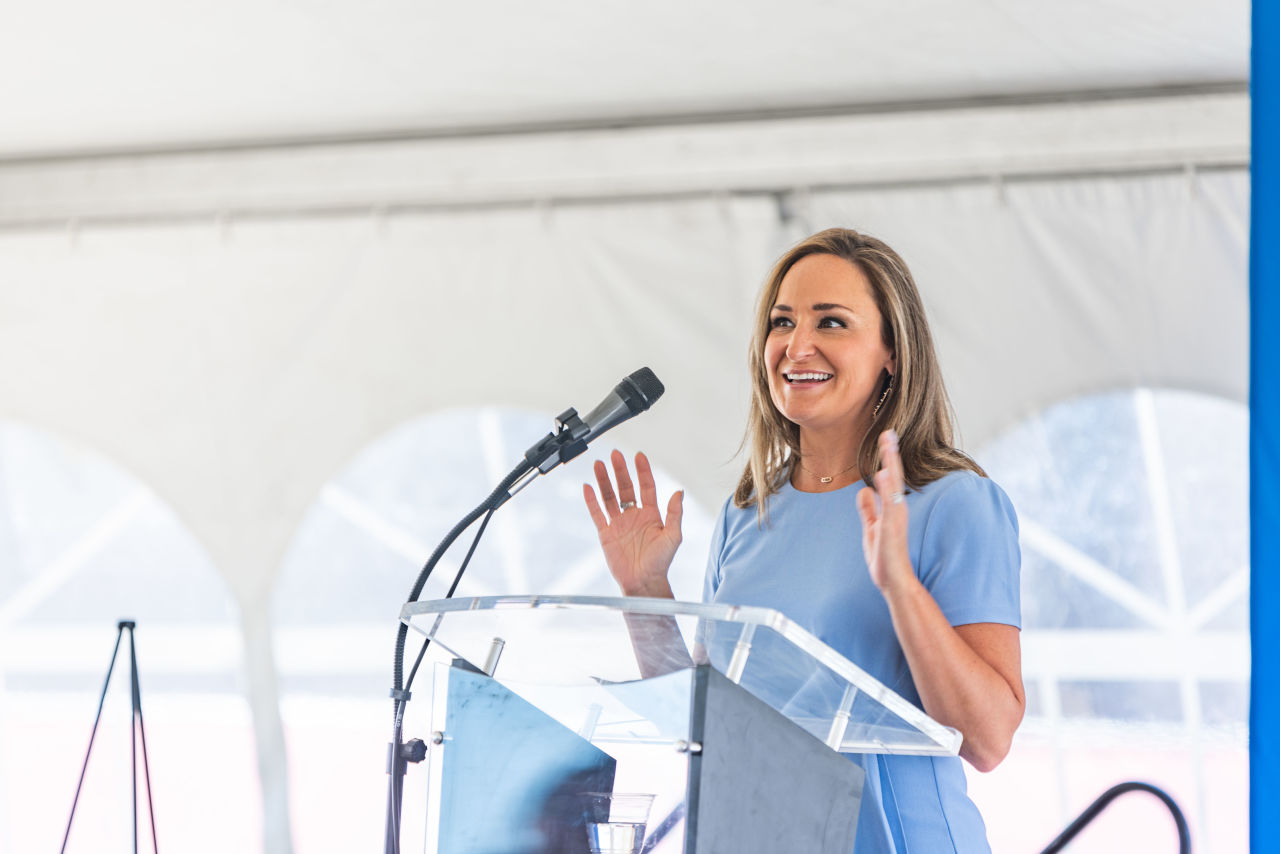 A woman talking at a podium.