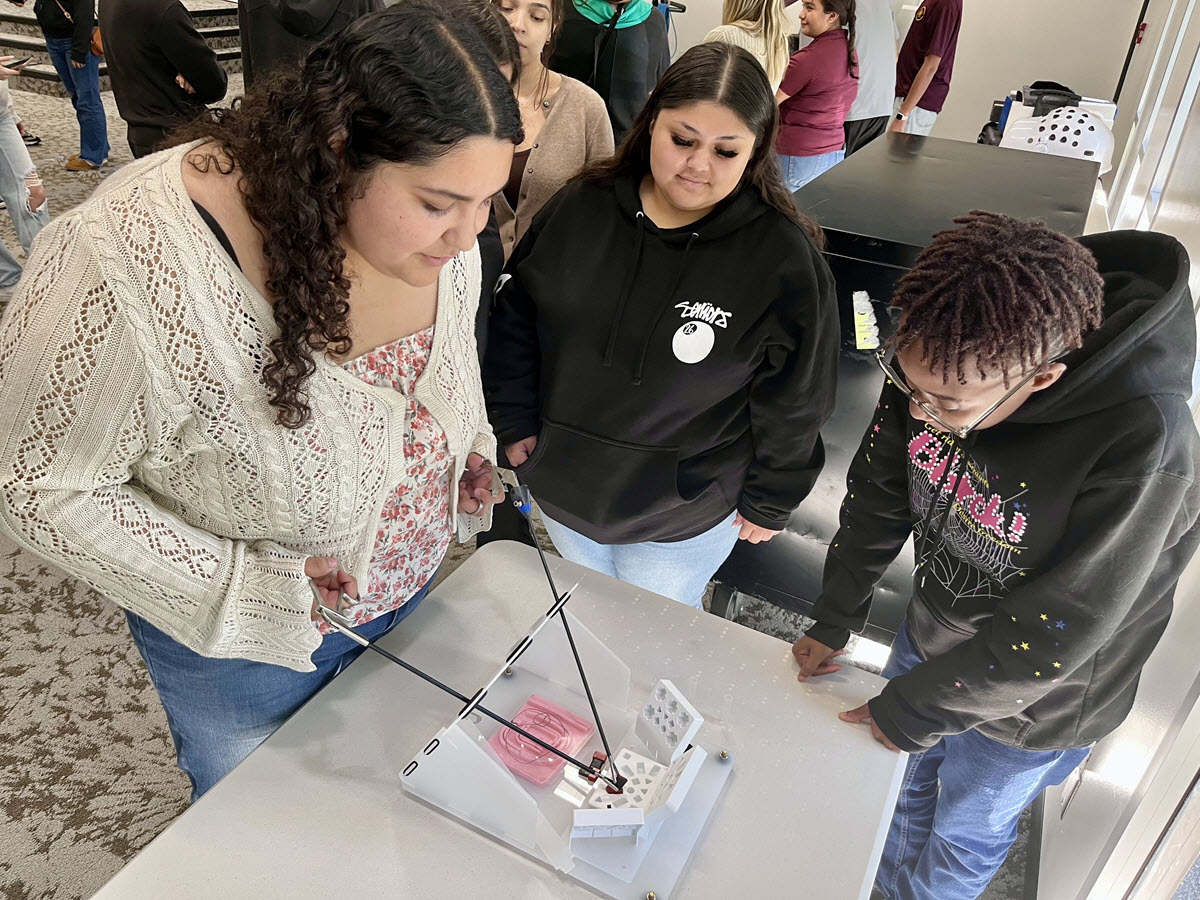Students guiding instruments used in robotics.