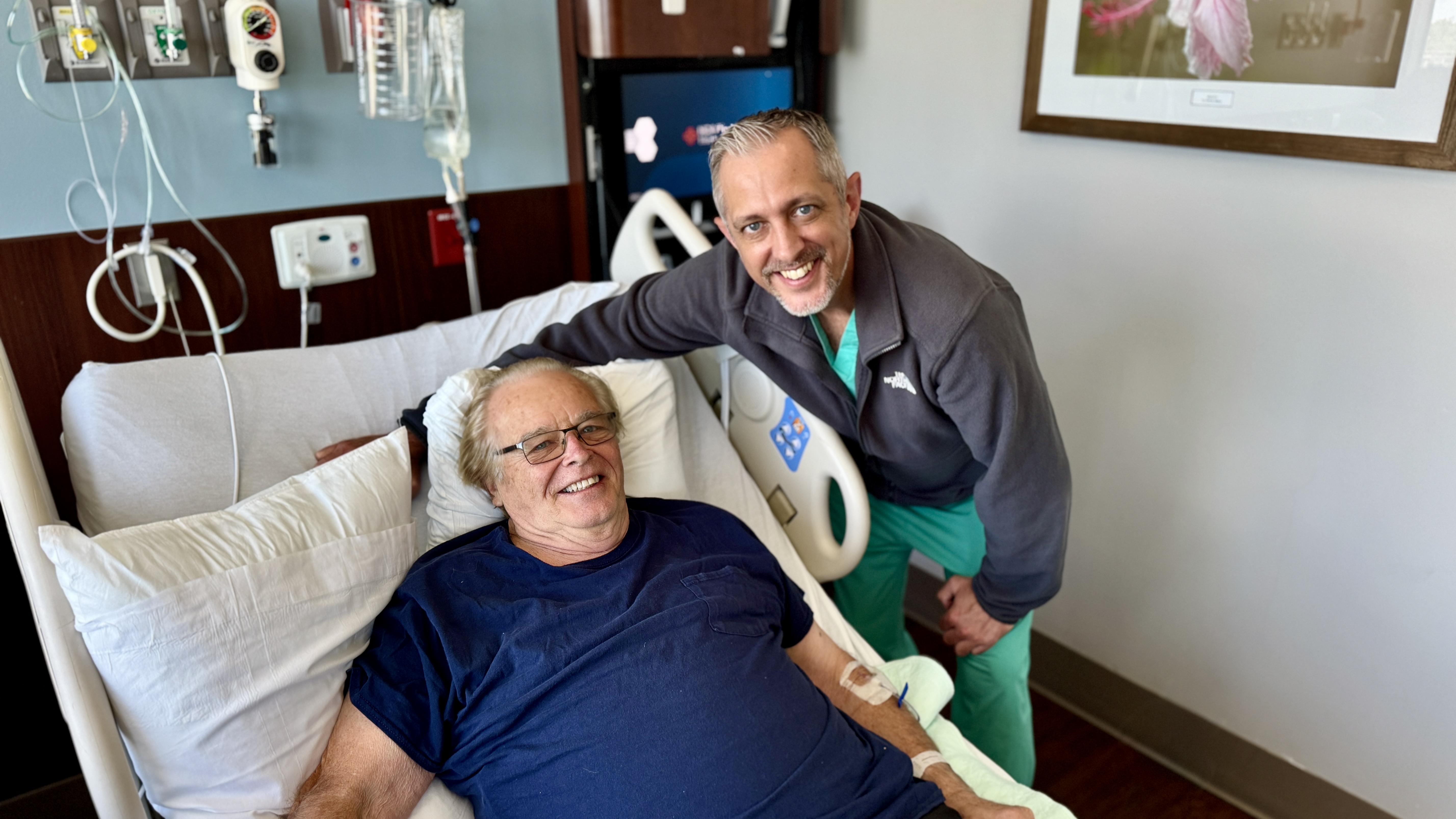 male patient in patient room bed with doctor