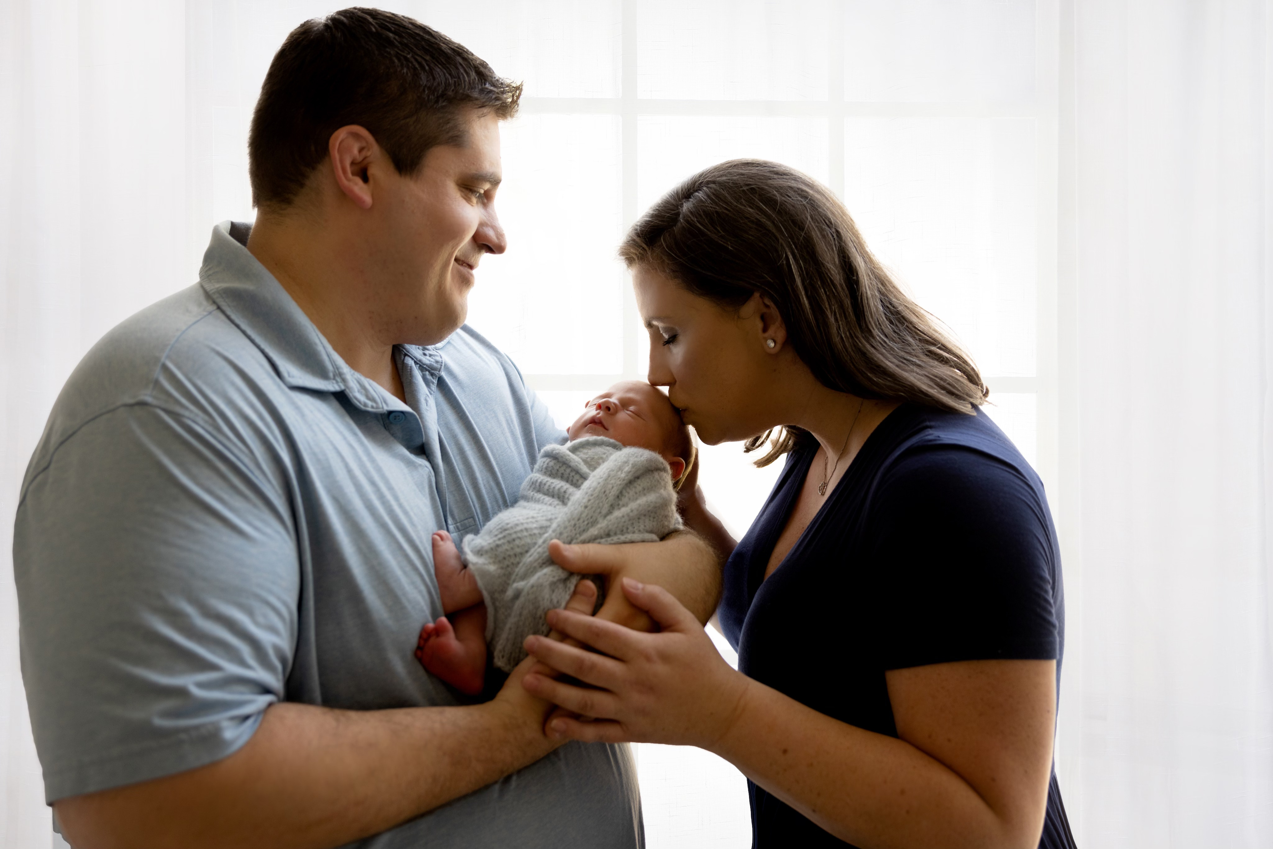 Tamsen Huff with her baby being held by her husband