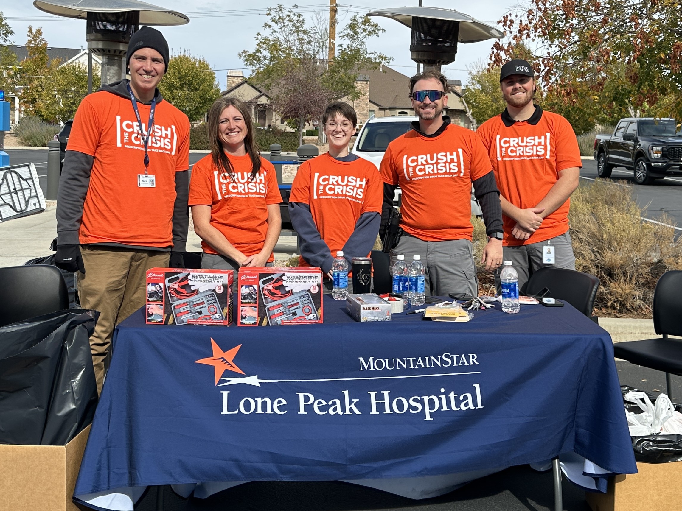 HCA team members outside at Crusht he Crisis reception table.