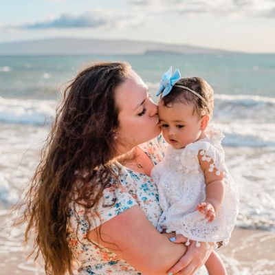 Maranda Kealamakia holding her baby on the beach.