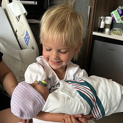 Quinn O’Shaughnessy holds a baby doll given to her by nurse Hannah.