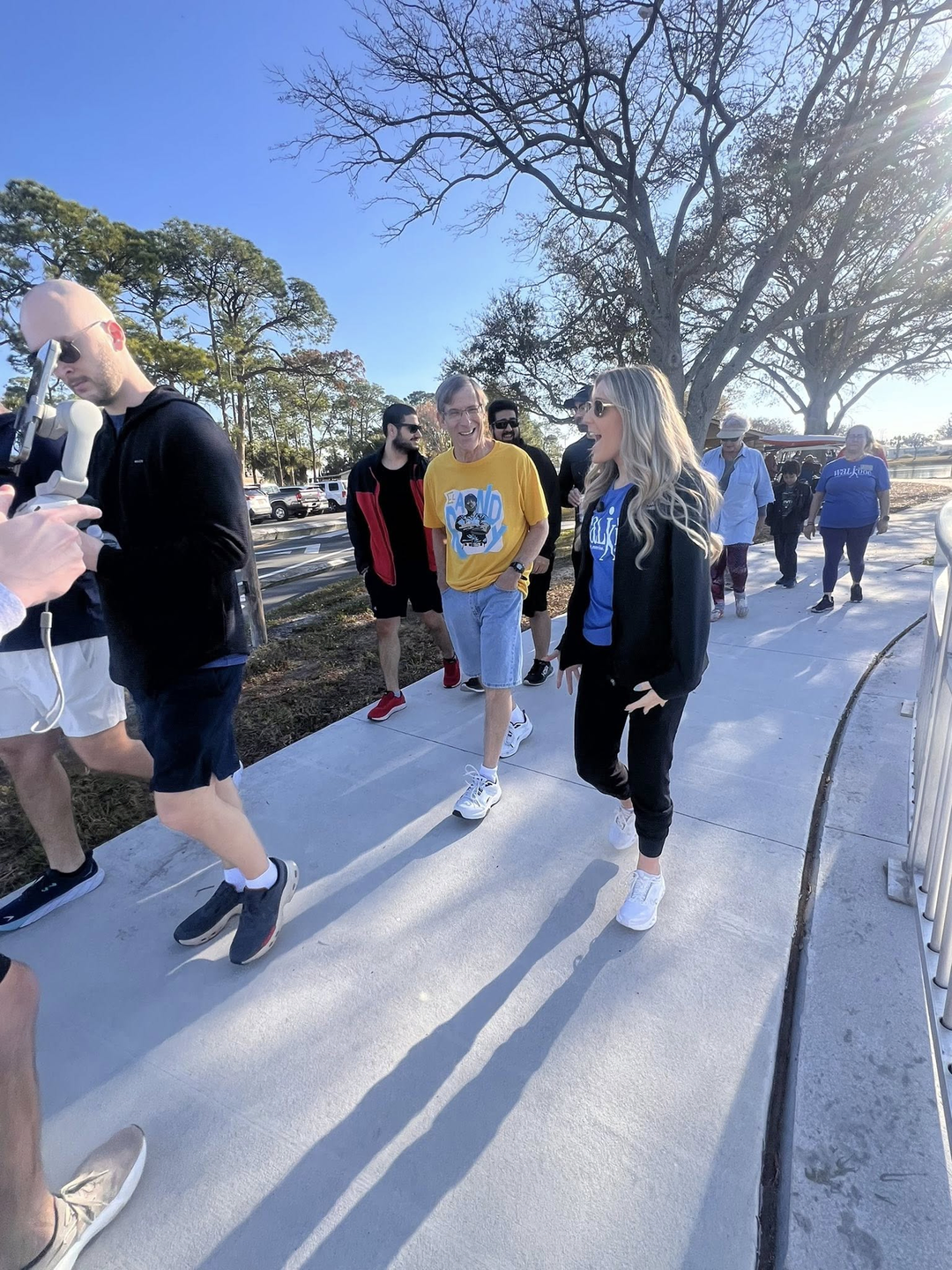 Photo showing of group of people walking and talking.