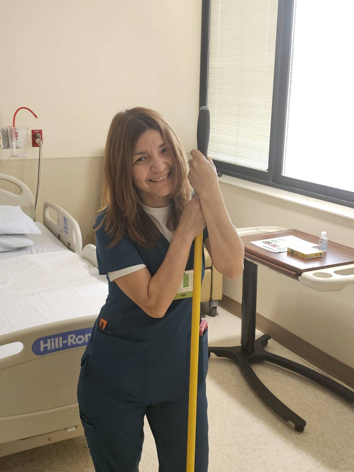 Patricia Hinojosa Mercado, Environmental Services Colleague at TriStar Hendersonville, posing with a mop