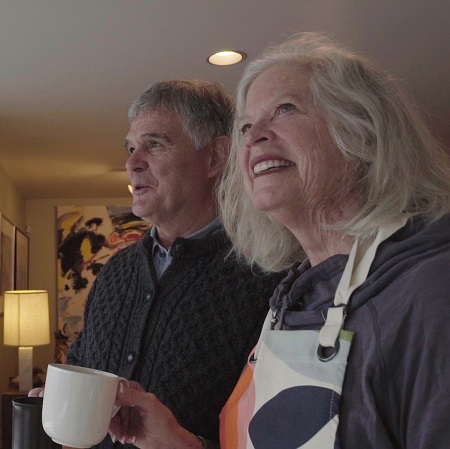 Rebecca Jacoby holding a coffee mug, next to her husband Robert.