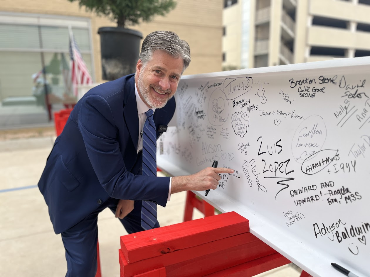 Employee signing the steel beam