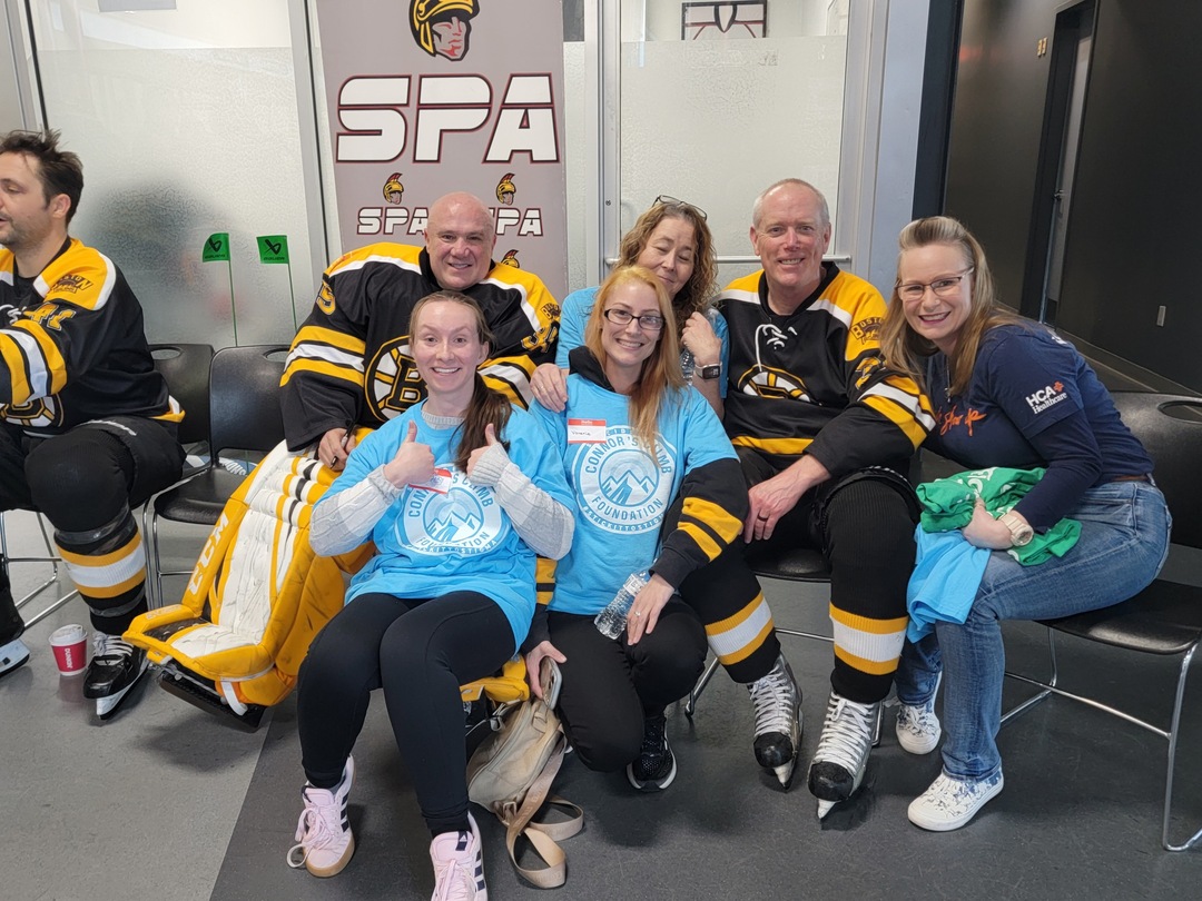 Colleagues relax after the 2026 Connors Climb Alumni Game.