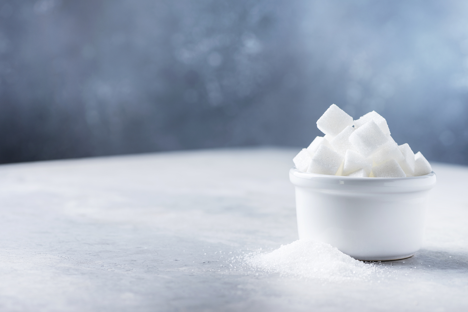 A ramekin dish of sugar cubes.