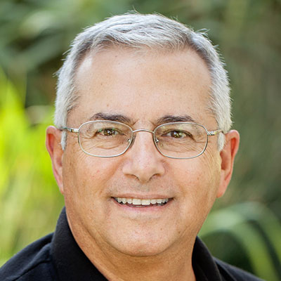 Patient Joe Cabral smiling and wearing eyeglasses.