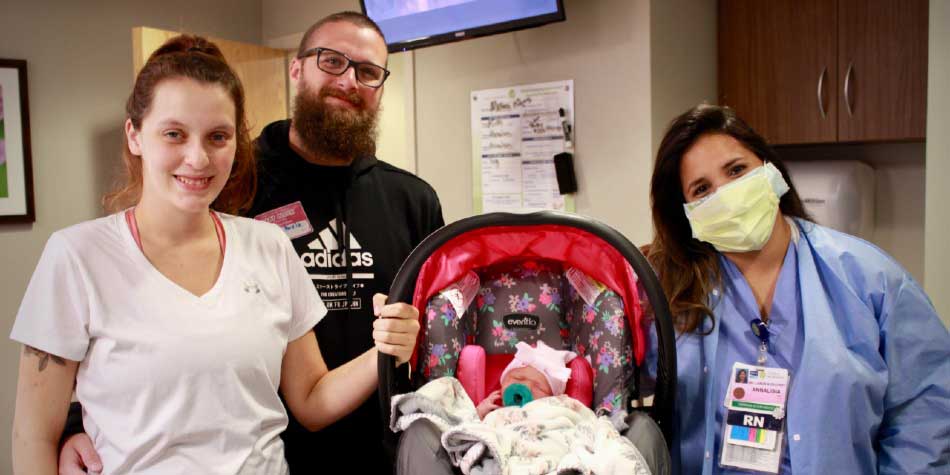 Makenzi, her husband Chris, baby Ruby, and their nurse