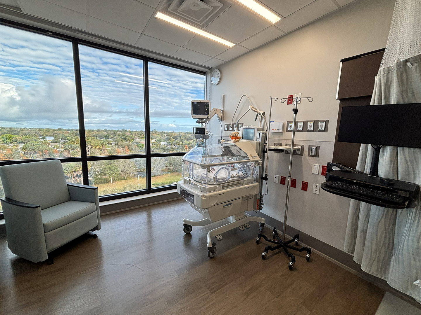 Labor and delivery room in Port St. Lucie Hospital with a newborn warming bed.