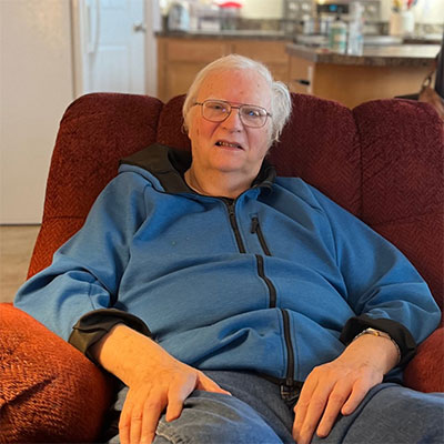 Larry Bailey sitting on a recliner.