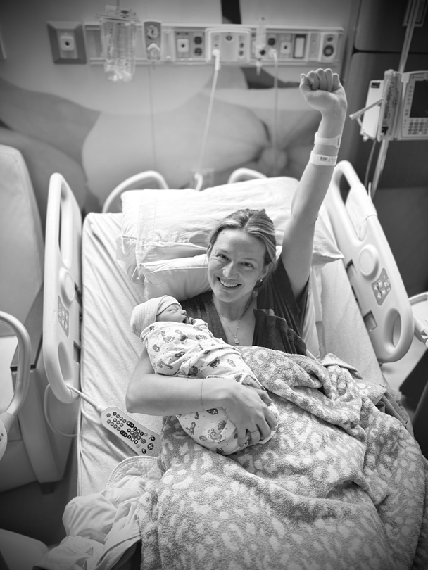 Mackenzie holds Quinn and pumps her fist in the air.