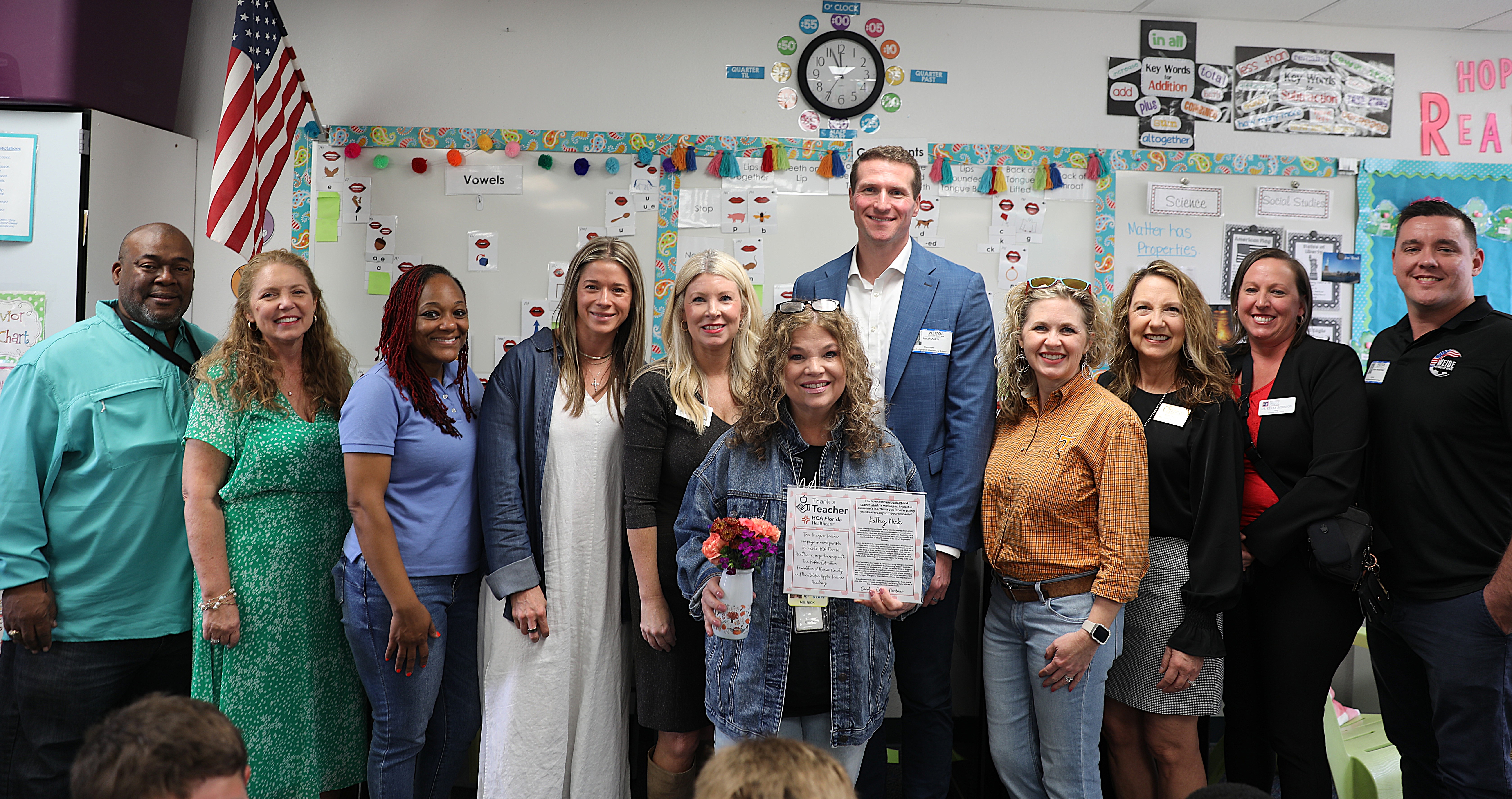 Kathy Nick, Isaiah Zirkle and school board members pose for group photo in classroom.