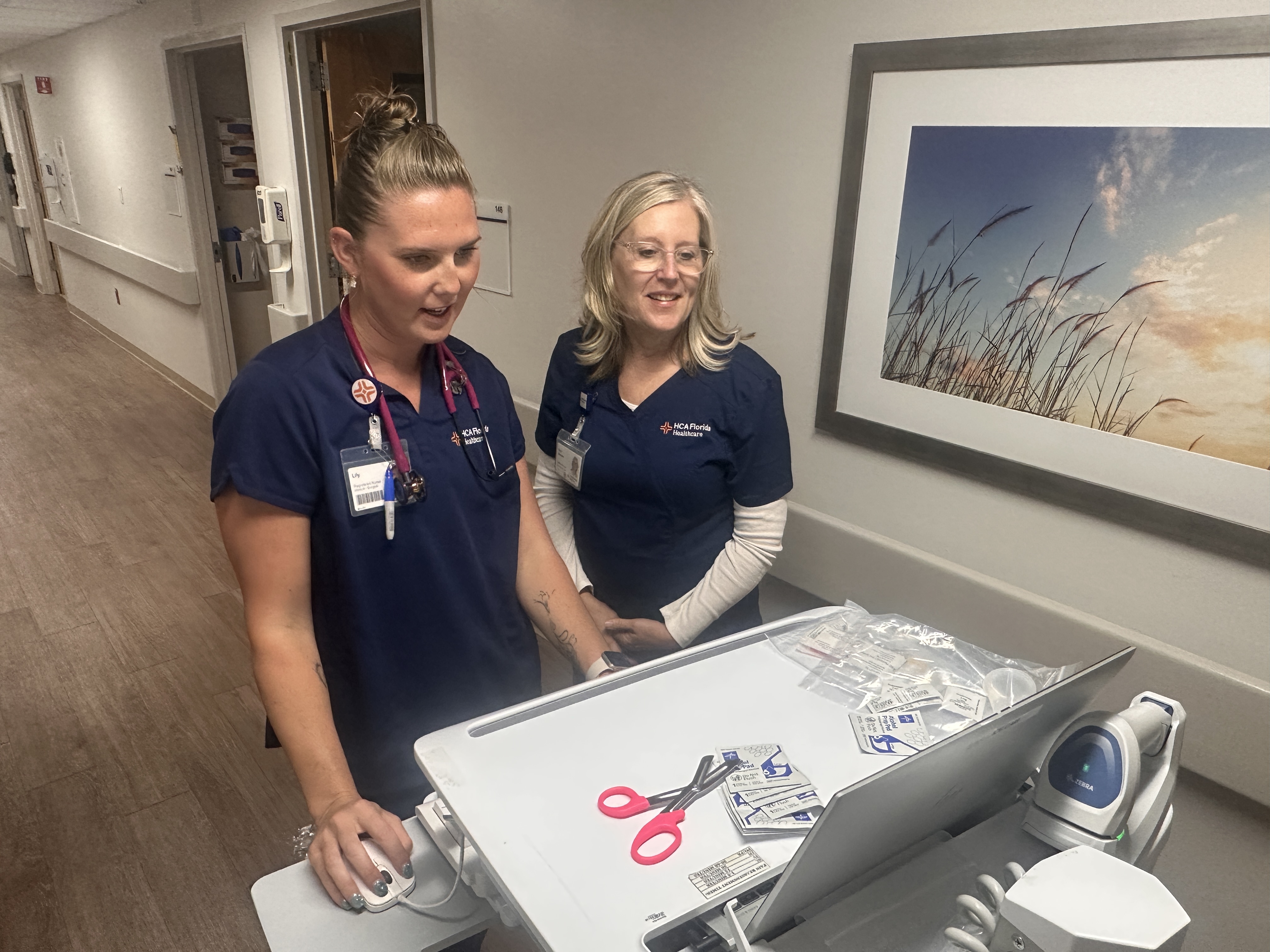 Lily Bakulski, RN (left), and Kimberly Becker (right) collaborate during a  job-shadowing experience at HCA Florida Englewood Hospital.