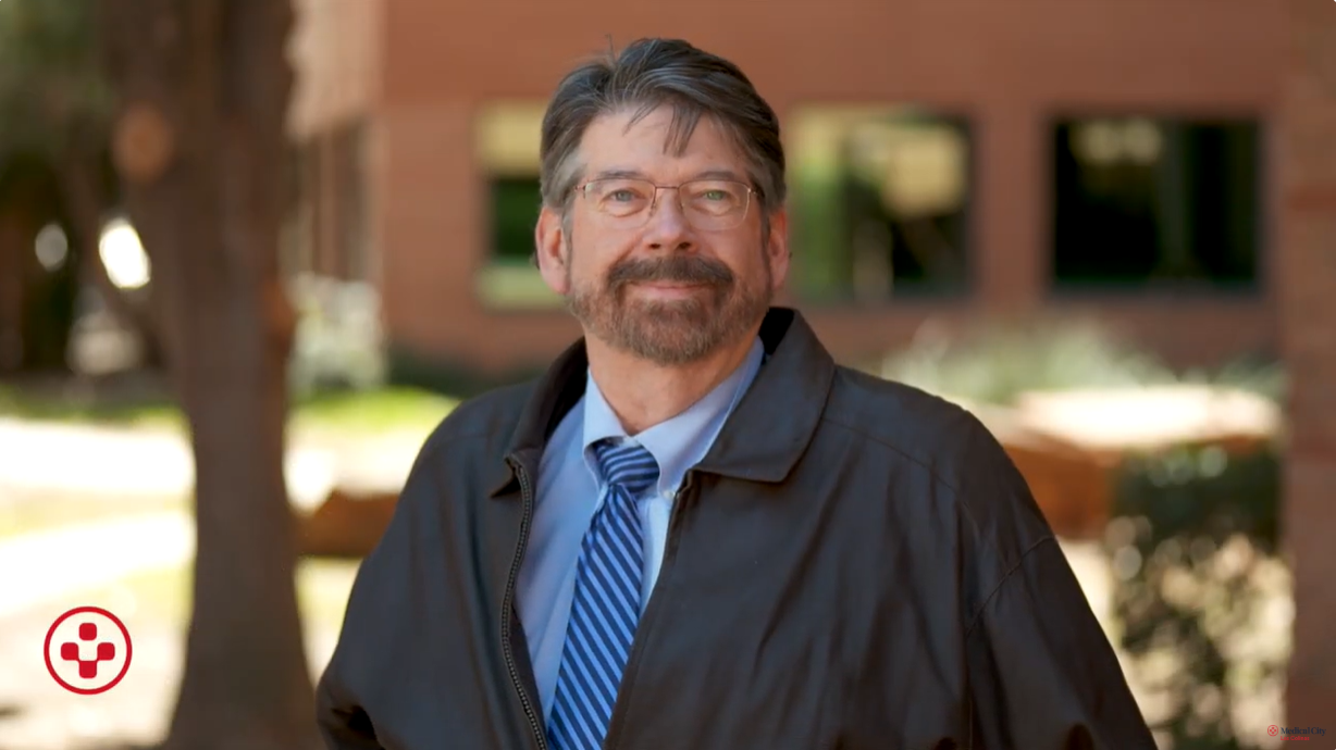 Paul Benson in a suit and striped blue tie