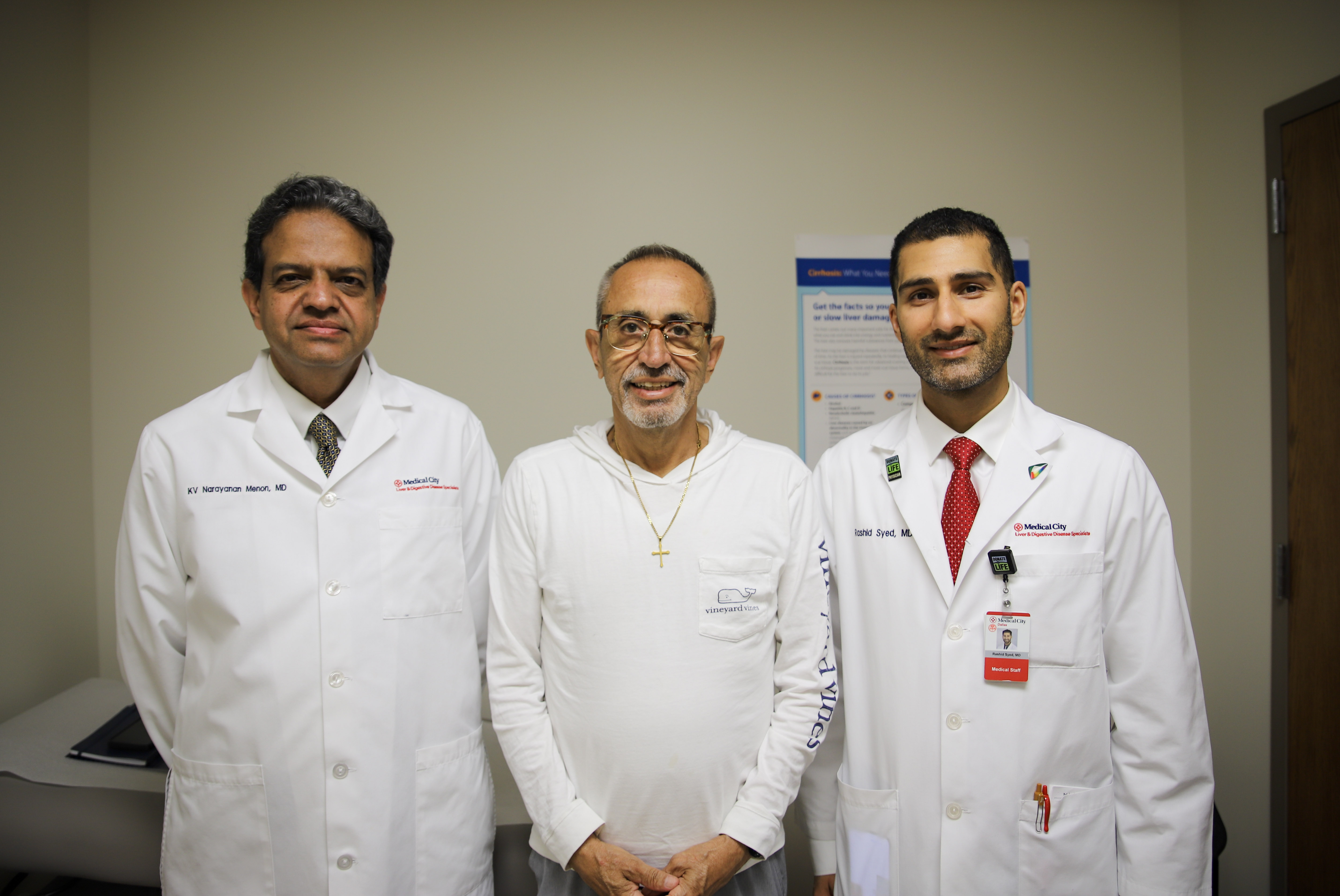 Physicians standing on either side of a patient