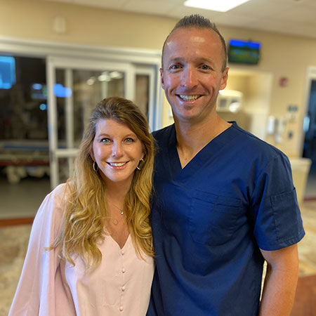Wendy Spradley and Dr. Daniel Humphreys smiling together in the ER lobby.