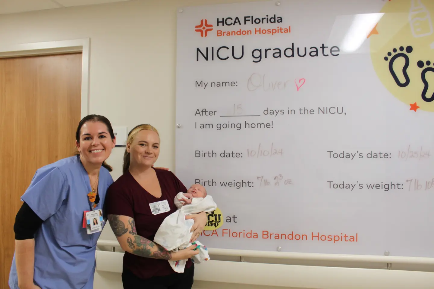 Oliver Lick and two NICU nurses on his "NICU Graduation" day.