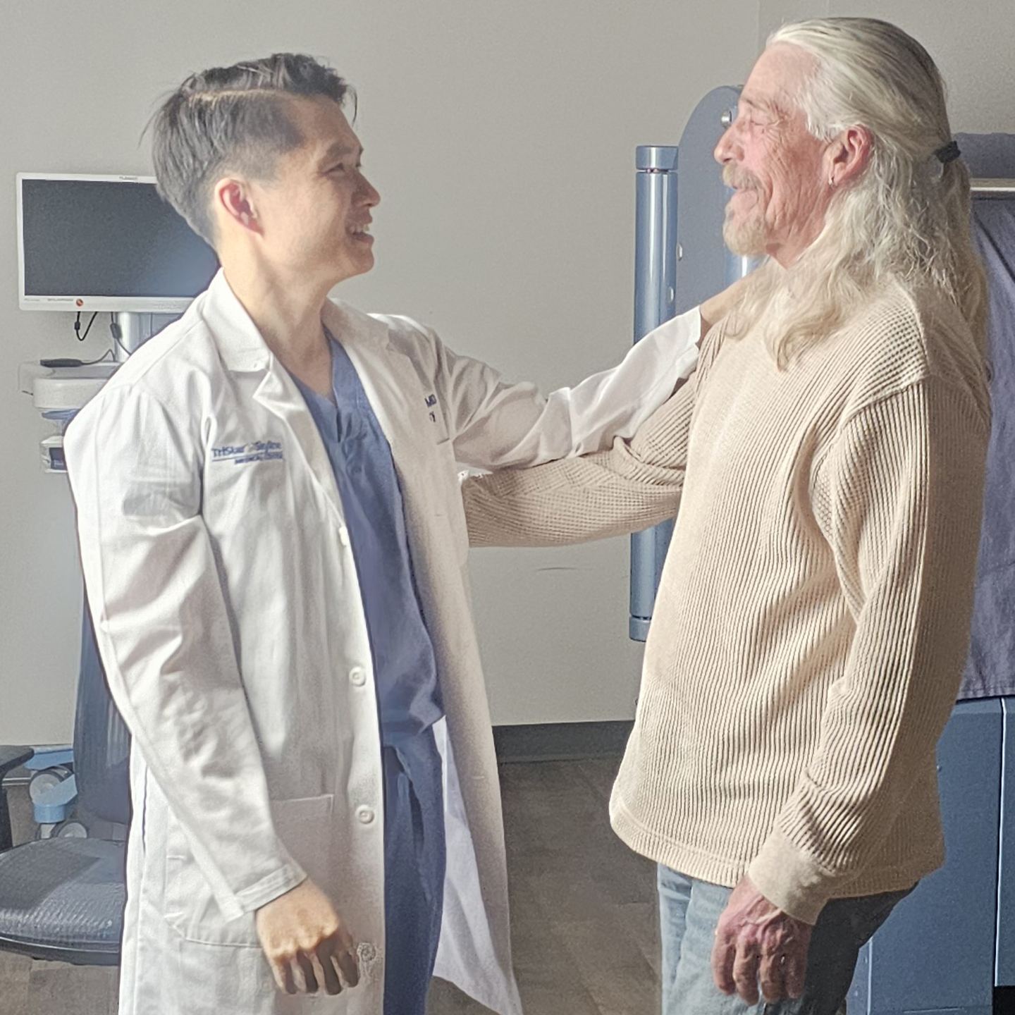 Dr. Tran and Bruce Hill talking with gestures