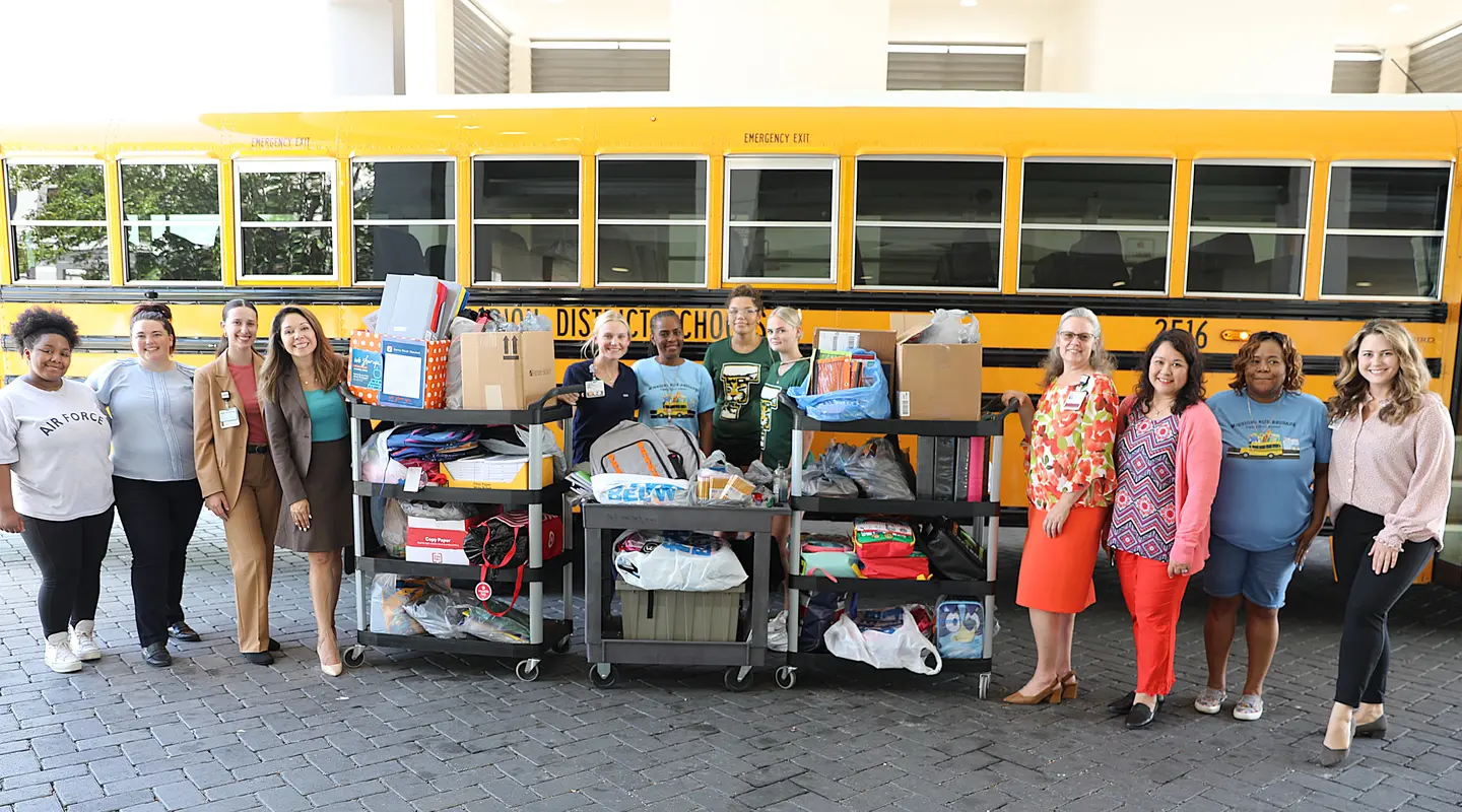 Florida Ocala and West Marion Hospital staff posing with school supply donation.