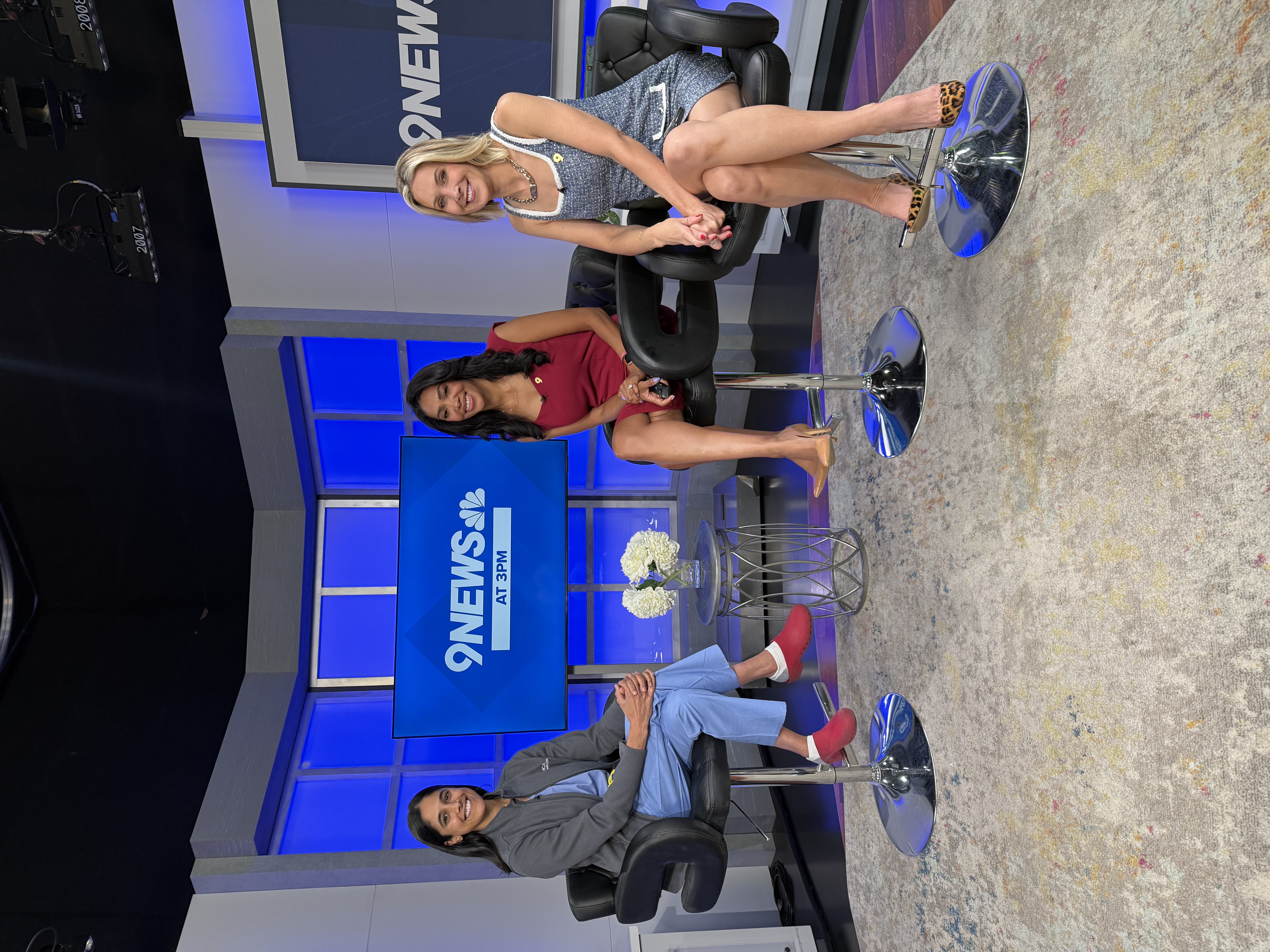 Dr. Seerat Poonia in a chair on the News9 set with two hosts