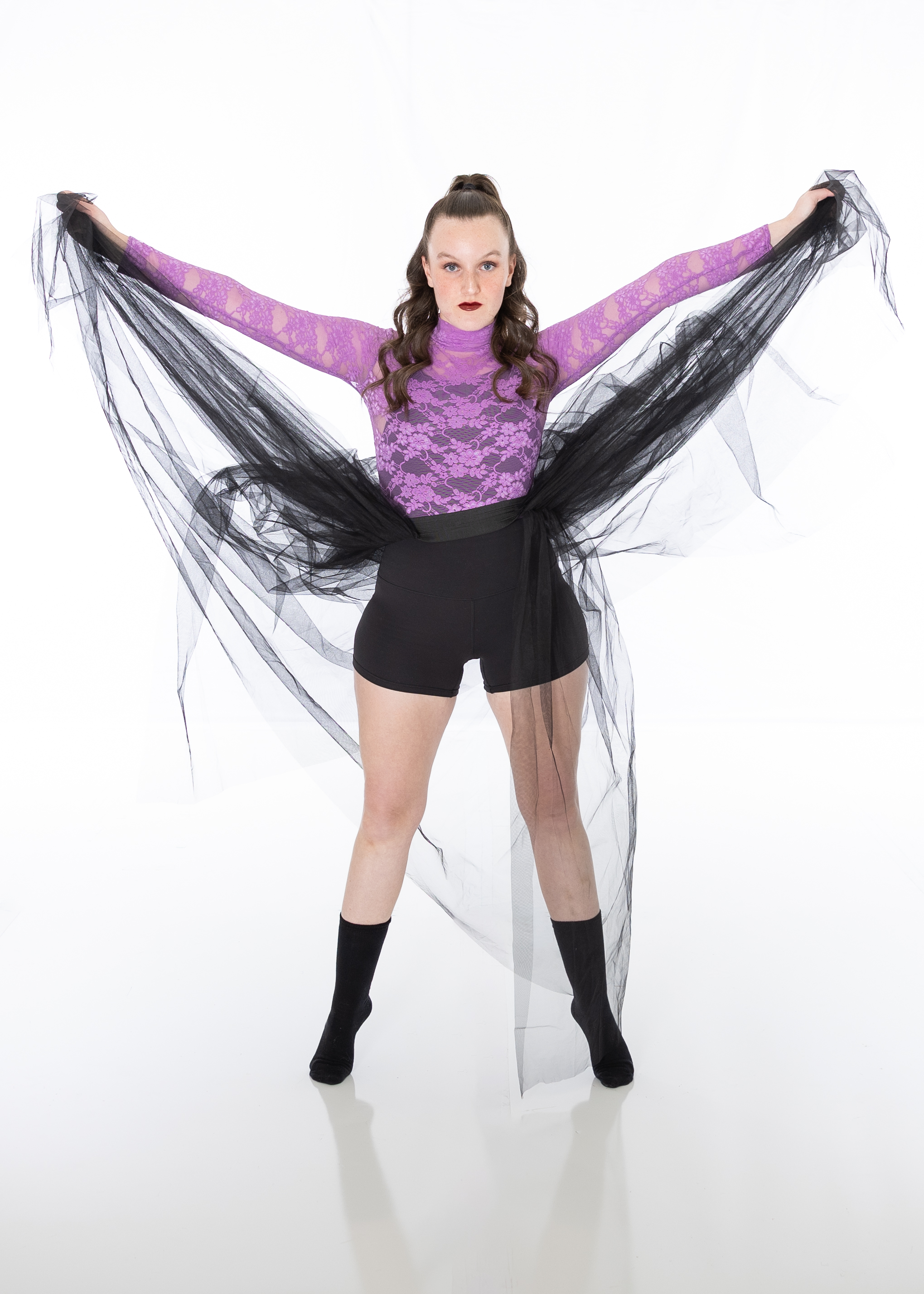 Sofia Clem wearing purple and black dancing attire with a black tutu.
