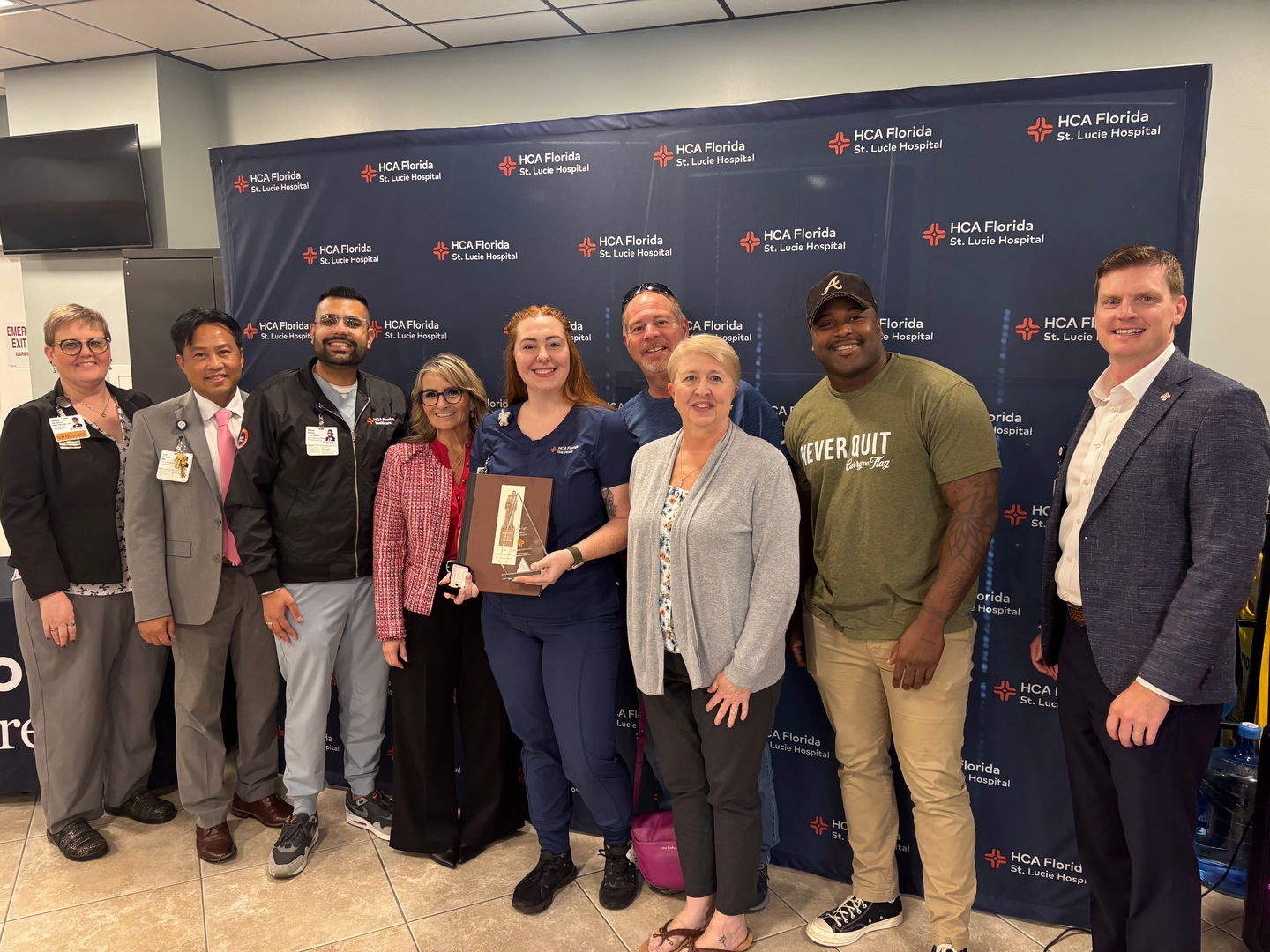 Rebecca Legg with her family and hospital leadership.