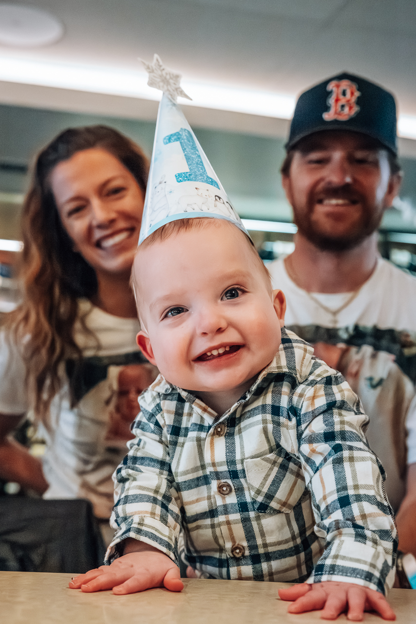 Baby hunter wearing a birthday hat that says 1.