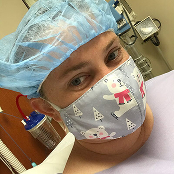 Mackenzie Mitchell wearing a surgical mask.