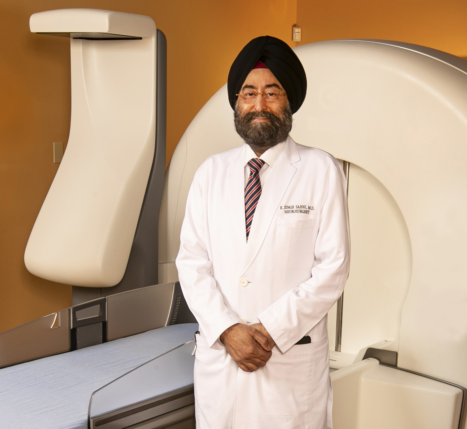 K. Singh Sahni, MD, Medical Director of the Neuroscience and Gamma Knife Center at HCA Virginia’s Johnston-Willis Hospital, stands in front of a surgical robot