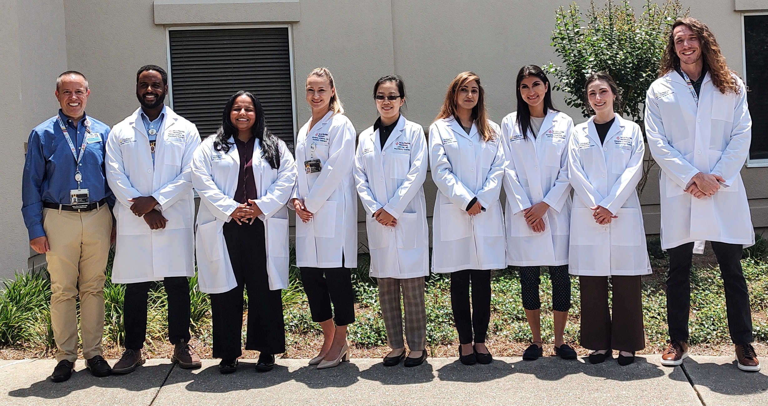 Group of eight new residents of Capital Hospital's Graduate Medical Education program.