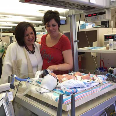 New mother Bridget Young along side her mother Angela Mayne to her right looks at her newborn Daniel.