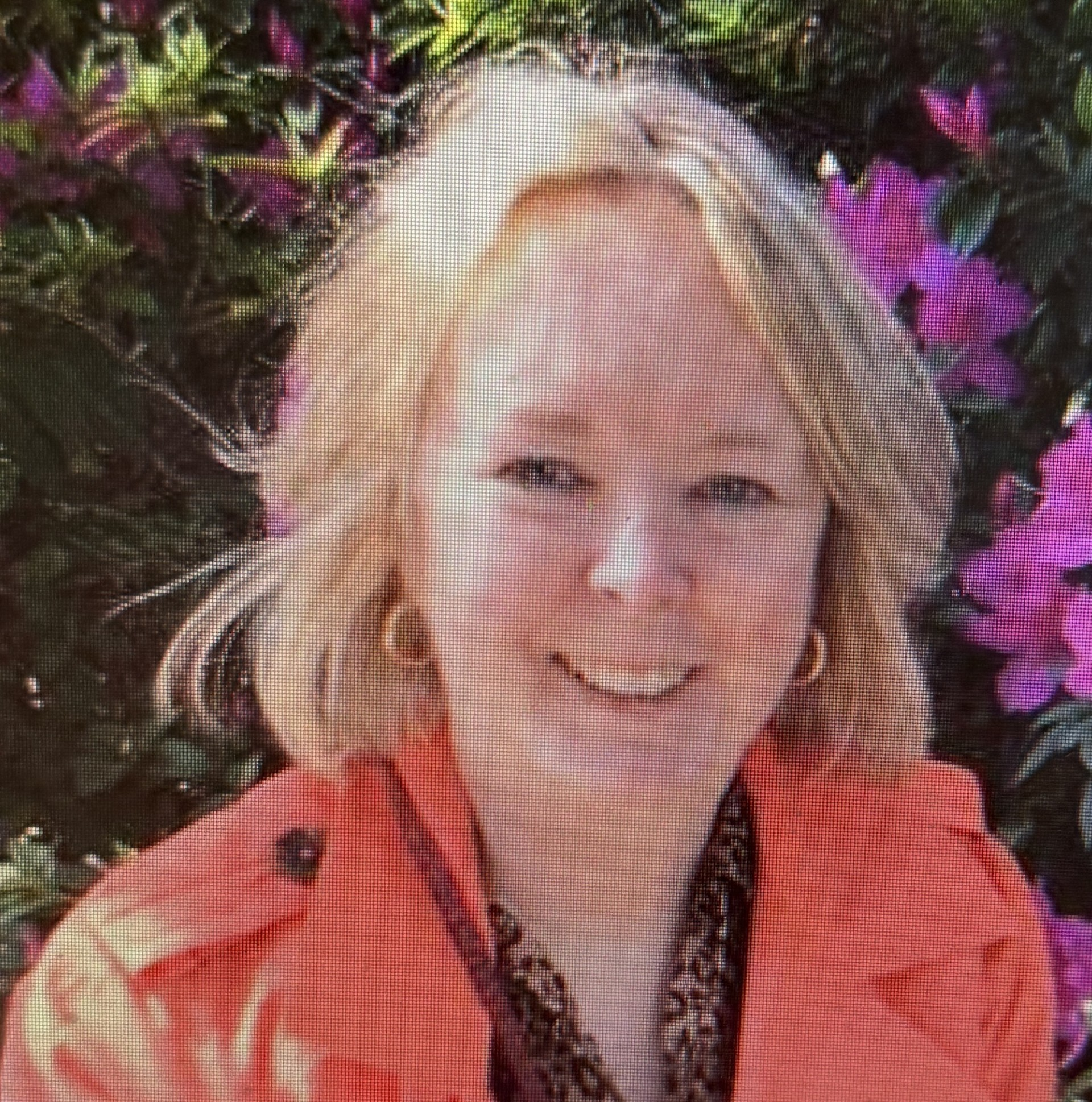 Debbie Kearney sitting happily outdoors.