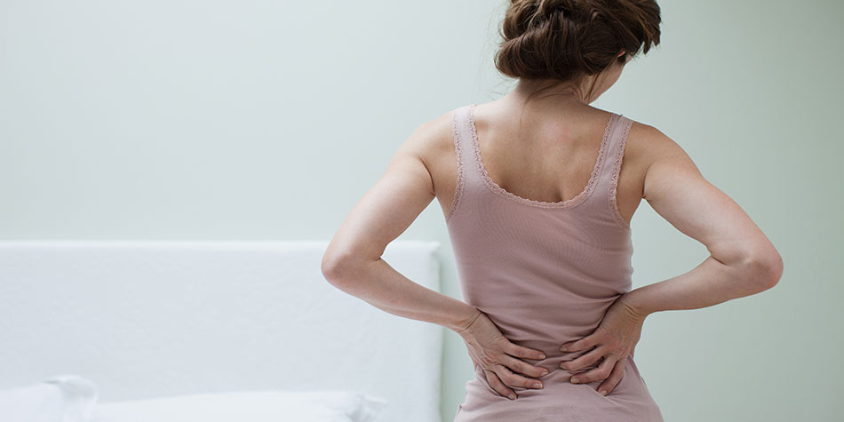 Woman in pain clutching her back 