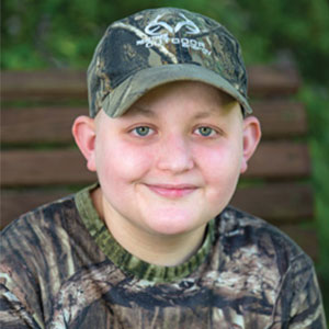 Hunter Stanfield wearing a camouflage hat and shirt. 
