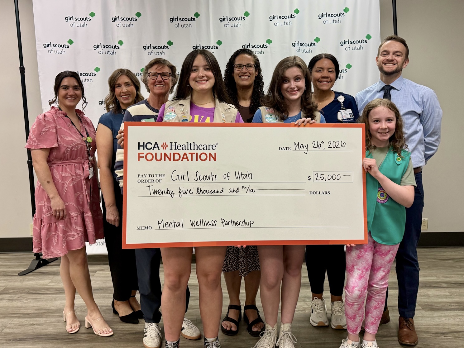 Leaders from HCA Healthcare's Mountain Division and Girl Scouts of Utah join local Girl Scouts with celebratory $25,000 check.