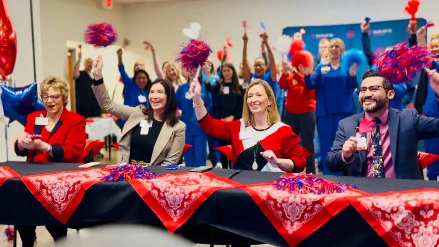 Medical City Fort Worth colleagues celebrate with pompoms.