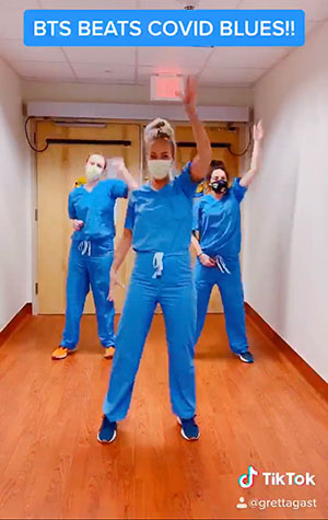 A screenshot of a TikTok video with hospital staff dancing and the words BTS Beats COVID Blues!! written at the top.