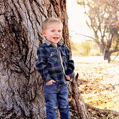 Anson Avalos standing next to a tree.