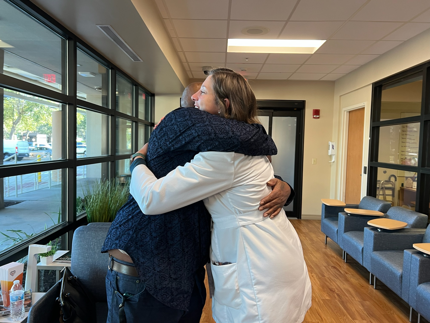 Debra Shine's husband gives Dr. Erricho a hug.