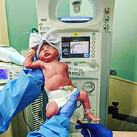 A newborn with bow hat.